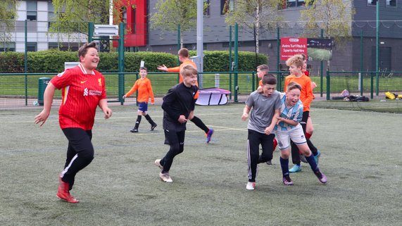 Participants celebrate scoring at our PL Kicks Tournament