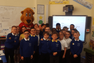 Roary and a class of children pose for a photo