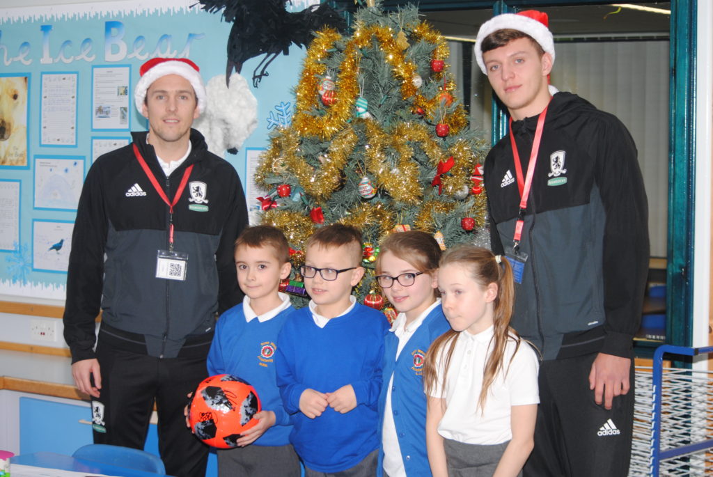 Stewart Downing and Dael Fry pose with children from Rose Wood Academy