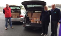 M F C Foundation staff load a van with boxes of crisps