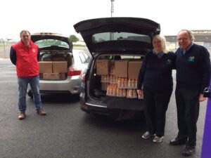 M F C Foundation staff load a van with boxes of crisps