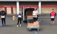 M F C Foundation staff help load orange juice onto a van