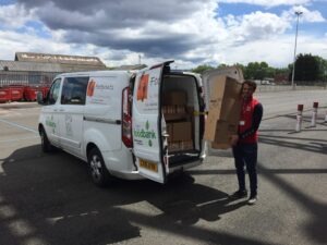 M F C Foundation's Dan helps load a van with crisps