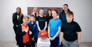 Left to right, back row, Mieka Smiles, Deputy Mayor of Middlesbrough, Helena Bowman, Head of Business Operations and Community at Middlesbrough Football Club, Lynsey Edwards, Head of Foundation, and Cleveland PCC Steve Turner. In the foreground, young people from Acklam Green Kicks with their artwork on discrimination and the environment.