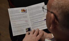 A participant reads through the programme of events