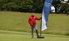 Middlesbrough FC Foundation's Fundraising and Events Coordinator Paul Murphy next to tournament sponsor Mandale Group's sail flag.
