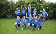 Group Winners in the 2024 Wilf Mannion Cup Archibald Girls display their trophy.